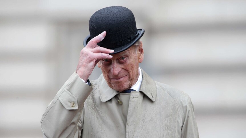 Prince Philip lifts his hat during his final solo engagement at Buckingham Palace in London.