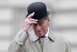 Prince Philip lifts his hat during his final solo engagement at Buckingham Palace in London.