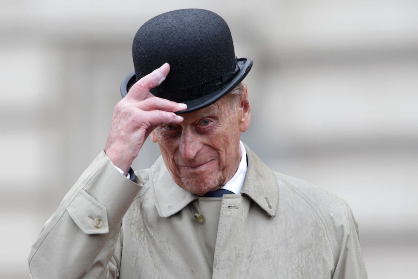 Prince Philip lifts his hat during his final solo engagement at Buckingham Palace in London.