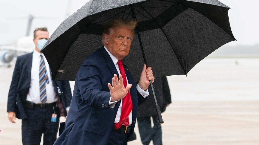 President Donald Trump waves with board Air Force One