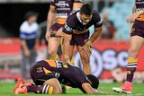 Anthony Milford lies on the ground after being hit by Sam Burgess