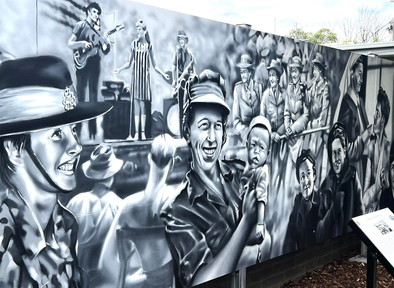 A black and white mural painting of women who have served or supported in wartime conflict 