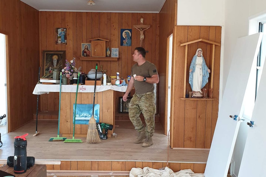 ADF member in army fatigues inside church that is under renovations