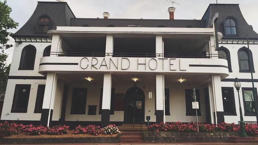 A picture of the front of a pub with a sign saying "Grand Hotel"