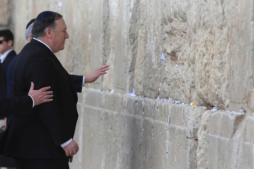 Wearing a yamulke and a black suit, Mike Pompeo prays at the Western Wall in Jerusalem.