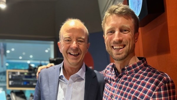 two men stand smiling in ABC Melbourne radio studio