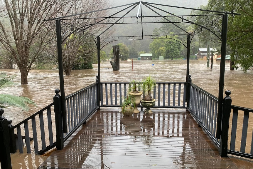 A balcony above a flooded river.