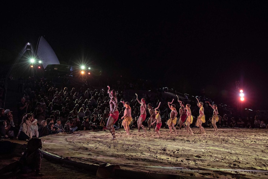 Colour photo of Muggera Dancers performing at Dance Rites 2018 at Sydney Opera House at night time.