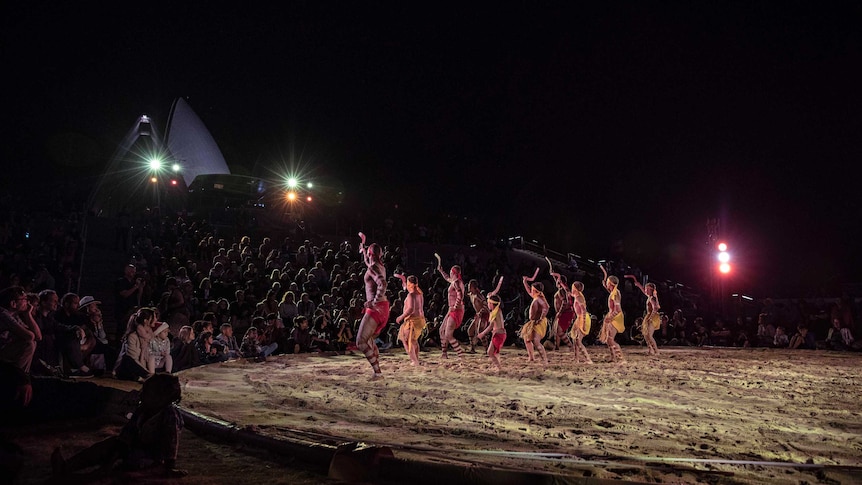 Colour photo of Muggera Dancers performing at Dance Rites 2018 at Sydney Opera House at night time.