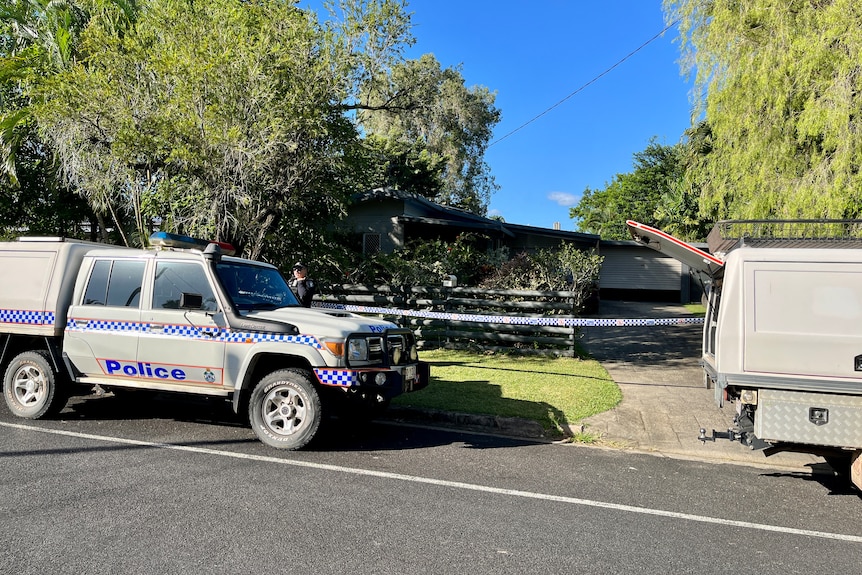 A house with police cars out the front. 