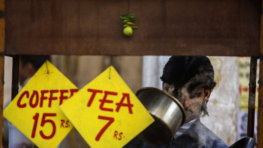 An Indian vendor makes tea in New Delhi