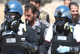 UN chemical weapons experts carry samples from one of the sites of an alleged chemical weapons attack outside Damascus.
