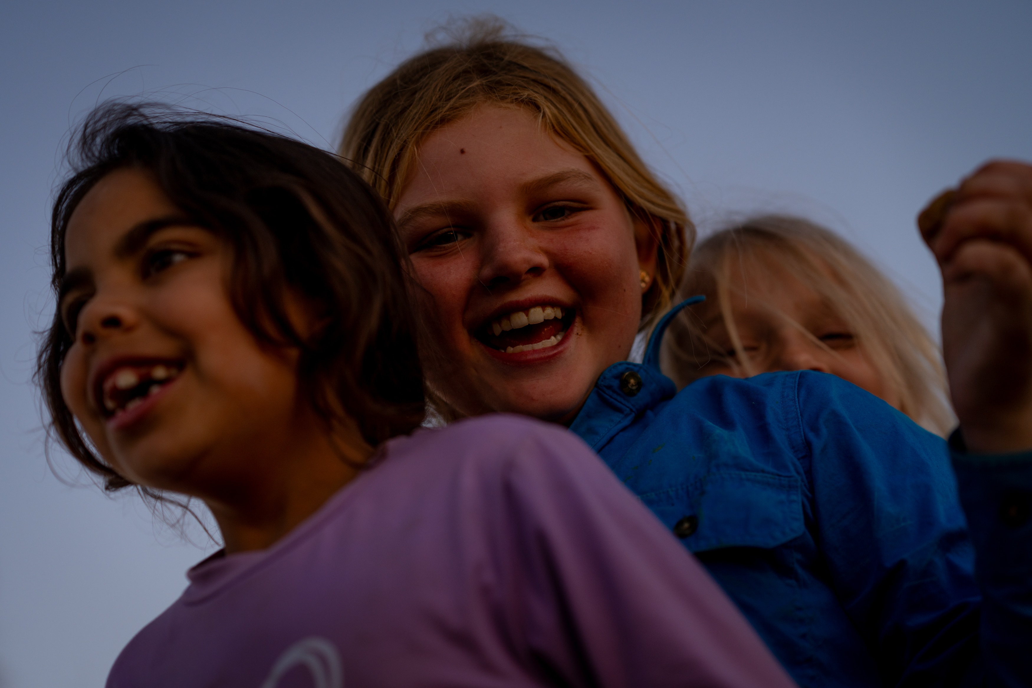 Taken from below, looking up at three happy young girls