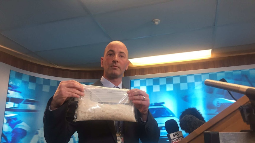 Tasmanian police officer holds package of ice