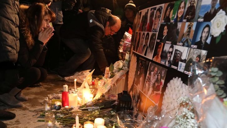 Mourners gather to pay tribute with candles and photos of victims of Ukrainian passenger jet which crashed in Iran.