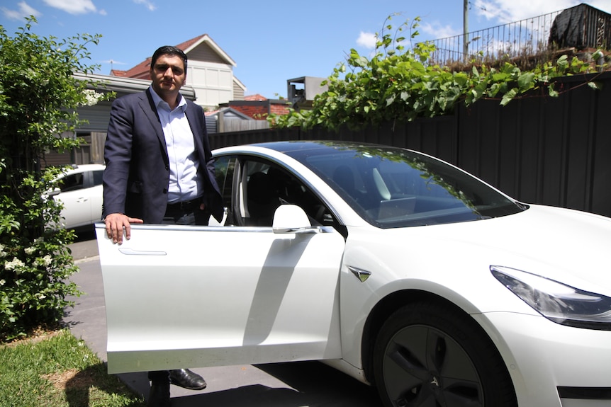 Behyad Jafari standing next to white car.