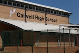 A sign reading Calwell High on a brick wall 
