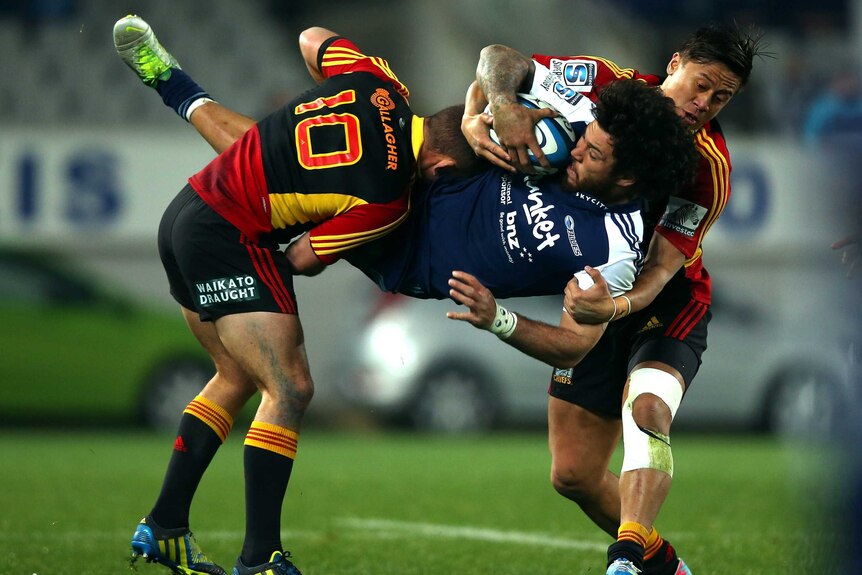 Defensive pressure ... Rene Ranger is dumped by Aaron Cruden (L) and Tim Nanai-Williams