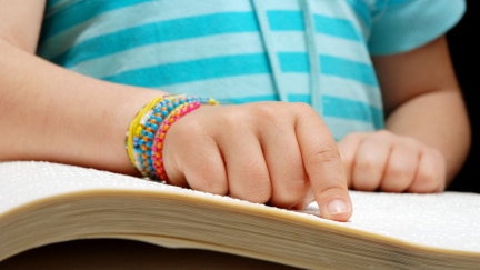 Child reading braille