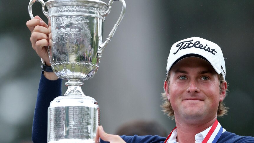 Webb Simpson celebrates with the trophy after winning the 112th US Open.