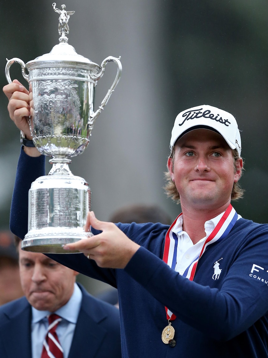 Webb Simpson celebrates with the trophy after winning the 112th US Open.