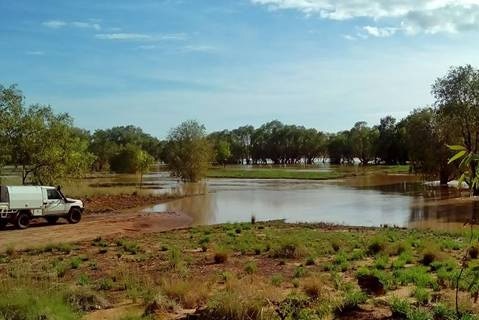 Myroodah crossing flooded by rainwater, with a four-wheel-drive parked at the edge of the water.