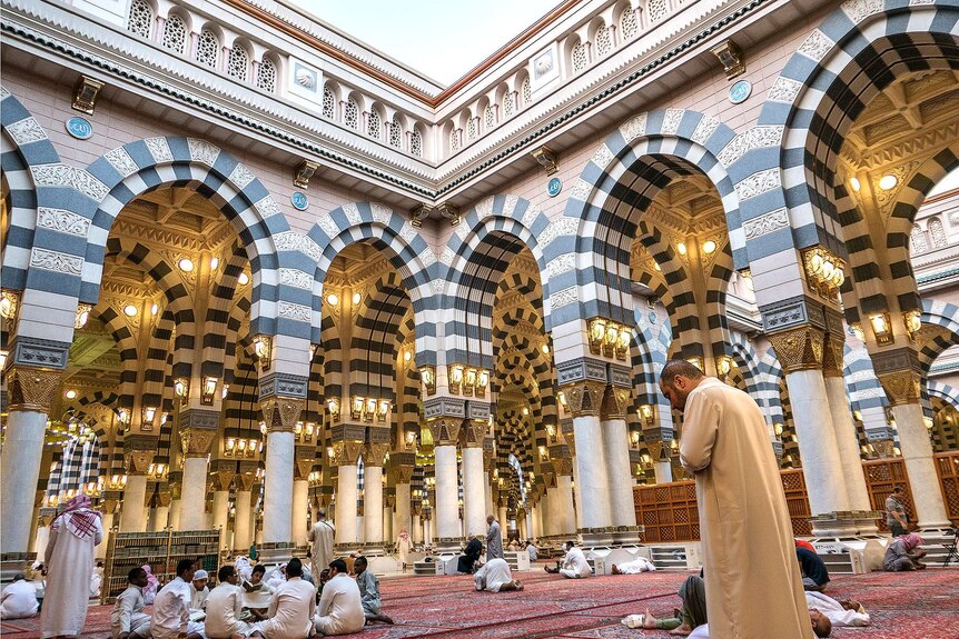 Muslims pray inside a spectacular mosque.