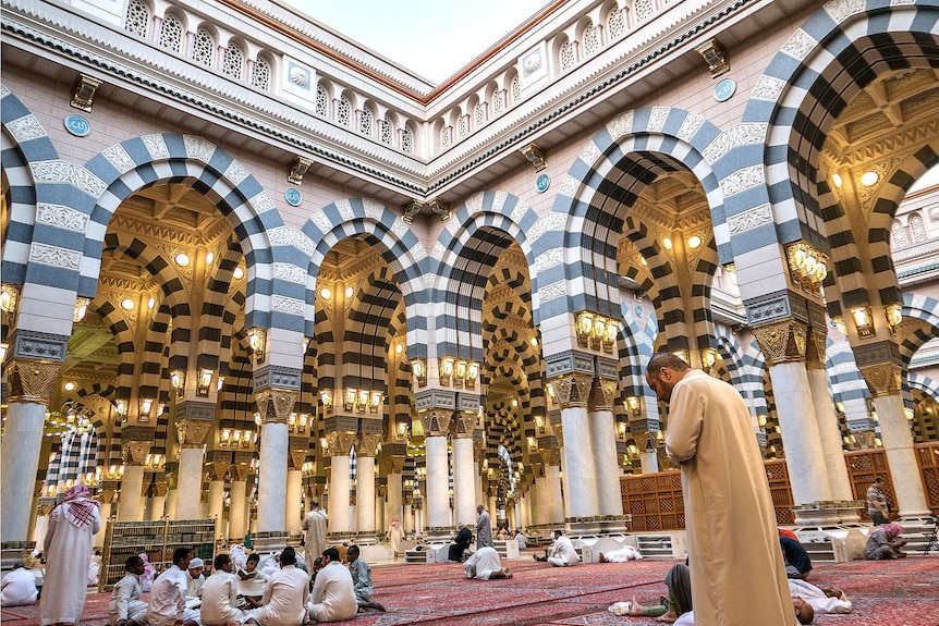 Muslims pray inside a spectacular mosque.