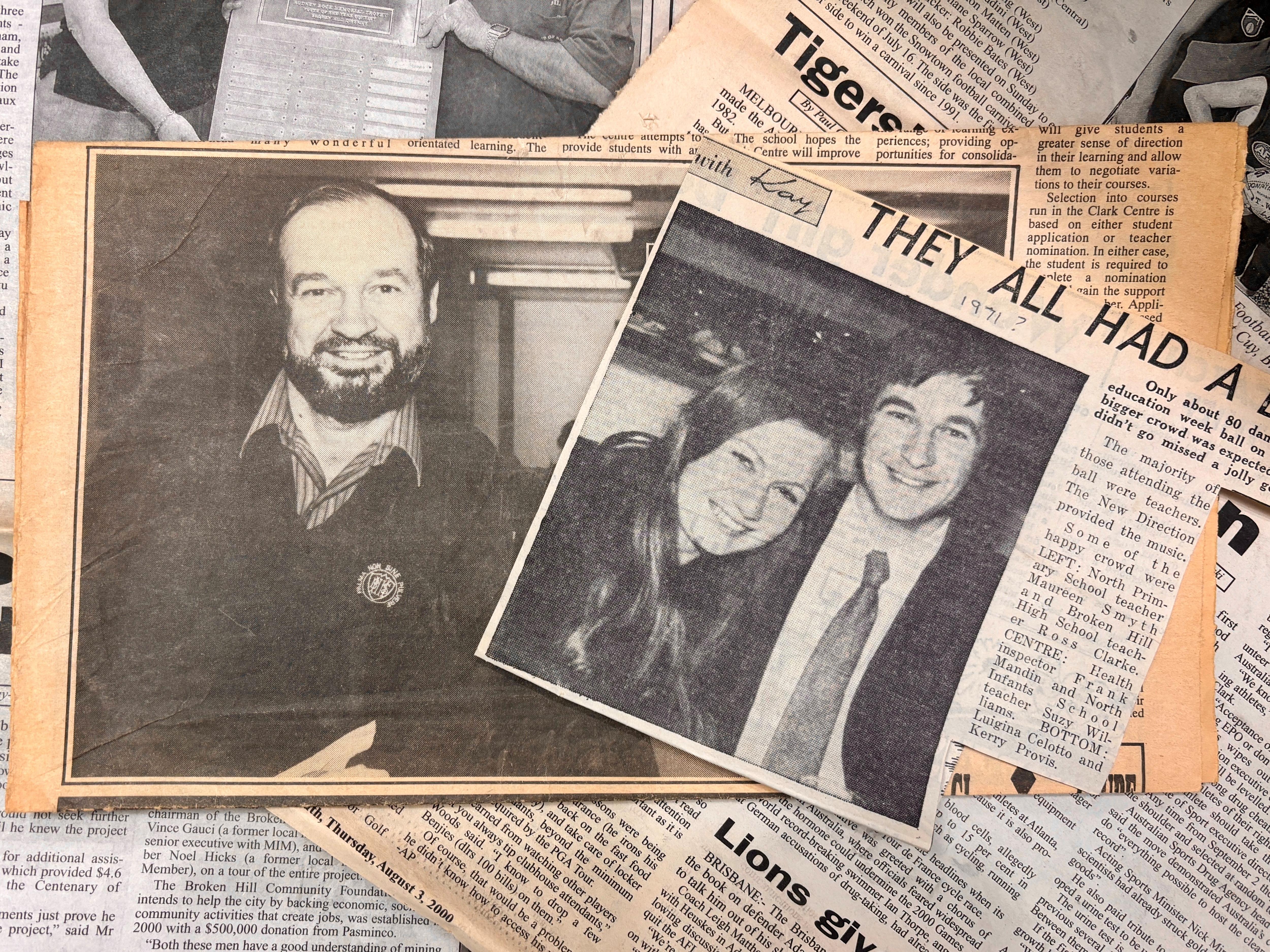 Two newspaper pages overlapping showing black and white photos of a man and a woman
