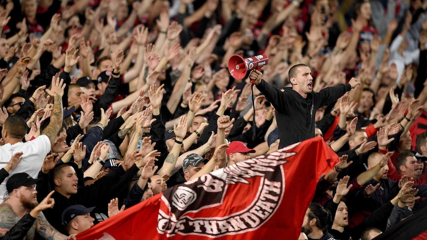 The Wanderers' core supporter group the Red and Black Bloc in the crowd at Sydney's Olympic stadium.