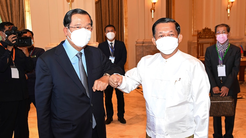 Cambodian Prime Minister Hun Sen (left) bumps forearms with Myanmar Senior General Min Aung Hlaing.