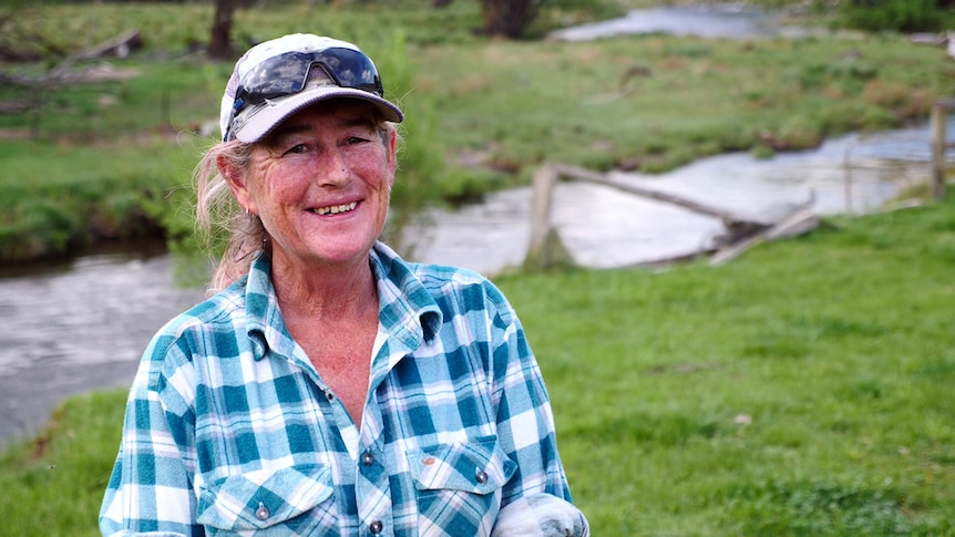 Catherine MCCoy standing on Anglers Rest farm near river.