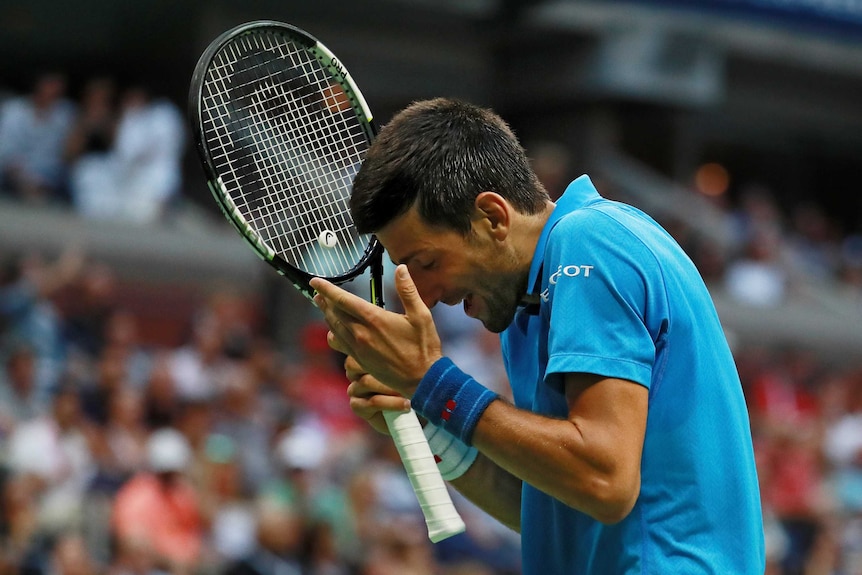 Feeling the pressure ... Novak Djokovic reflects during the final against Stan Wawrinka