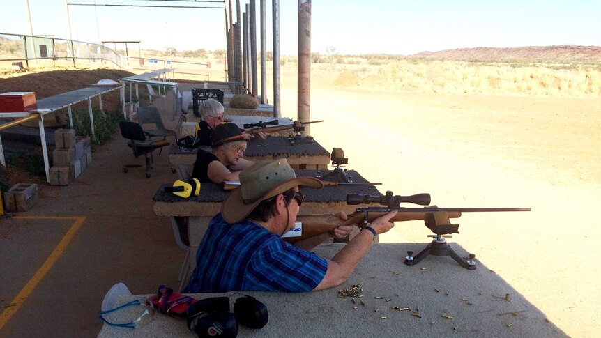 A shot of sports shooters aiming their guns at targets