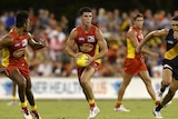 The Suns' Jaeger O'Meara on the run against Richmond at Carrara