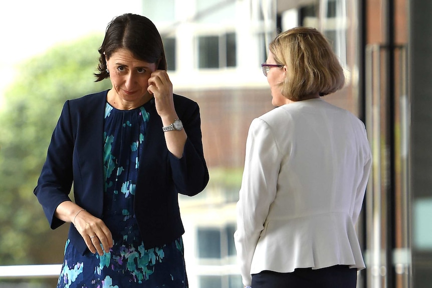 A photo of Gladys  Berejiklian and the back of Kerry Chant
