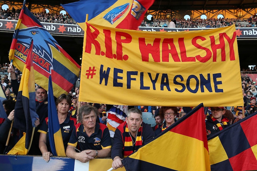 Crowd tributes ... Crows fans show their respect for the late Phil Walsh at Subiaco Oval