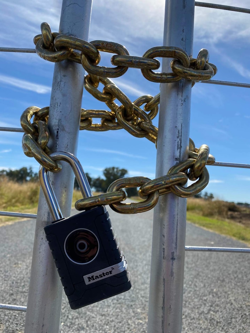 A gate is chained and padlocked.