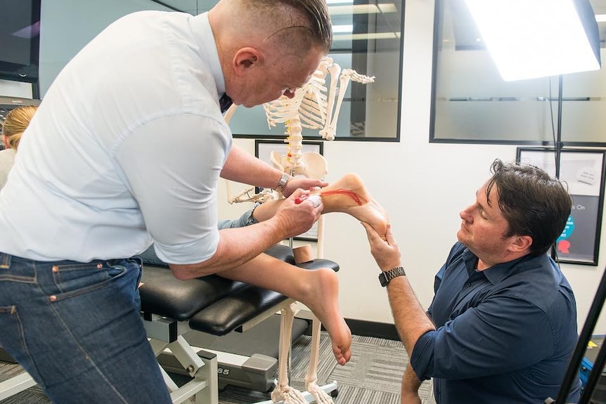 Podiatrists checking the heel of a child