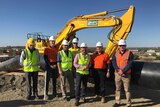 The Minister for Regional Water, Niall Blair, stands with a construction team.