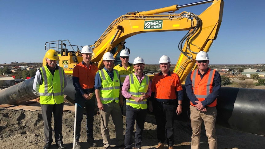 The Minister for Regional Water, Niall Blair, stands with a construction team.