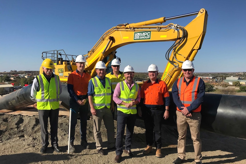 The Minister for Regional Water, Niall Blair, stands with a construction team.