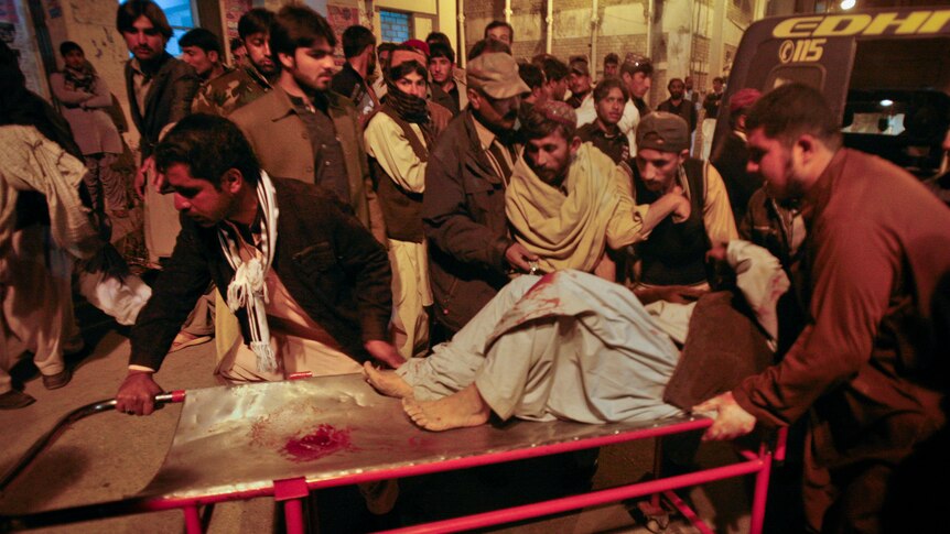 Deadly blast ... An injured man is rushed to hospital after the detonation in Quetta killed at least eight people.