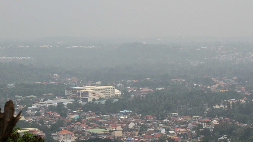 Thick haze from Indonesia's forest fires blankets the city of Davao, southern Philippines