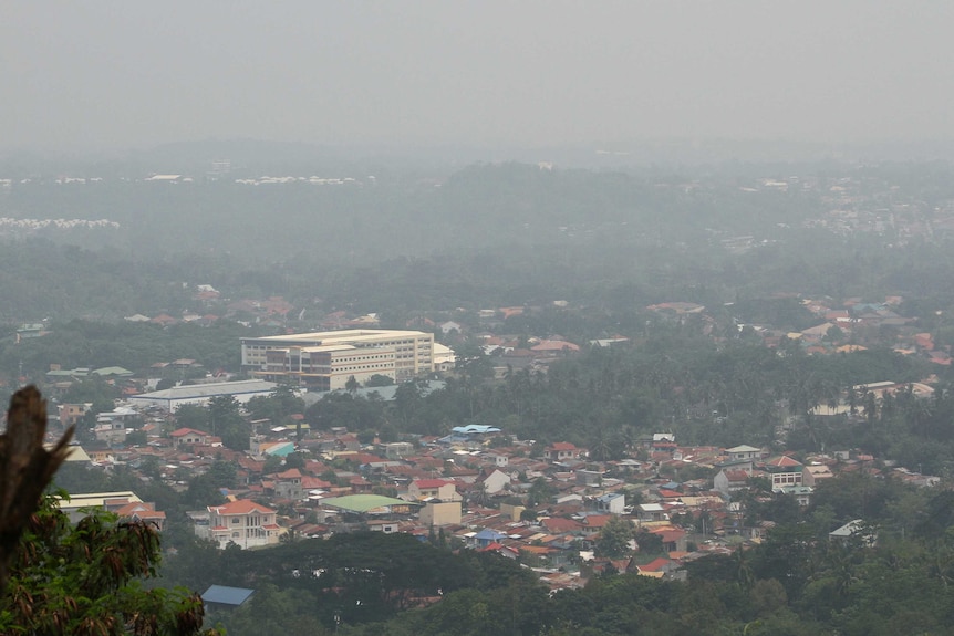 Thick haze from Indonesia's forest fires blankets the city of Davao, southern Philippines