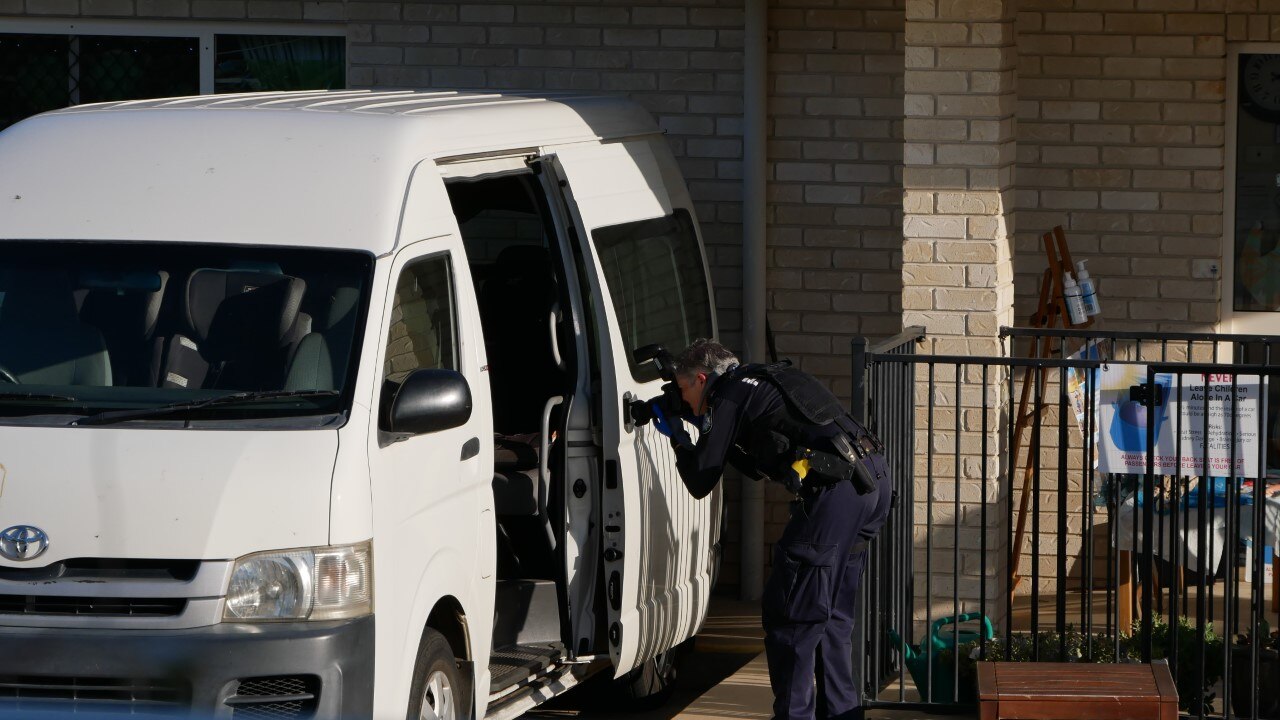 Investigating officer photographs a daycare minibus where a child was left