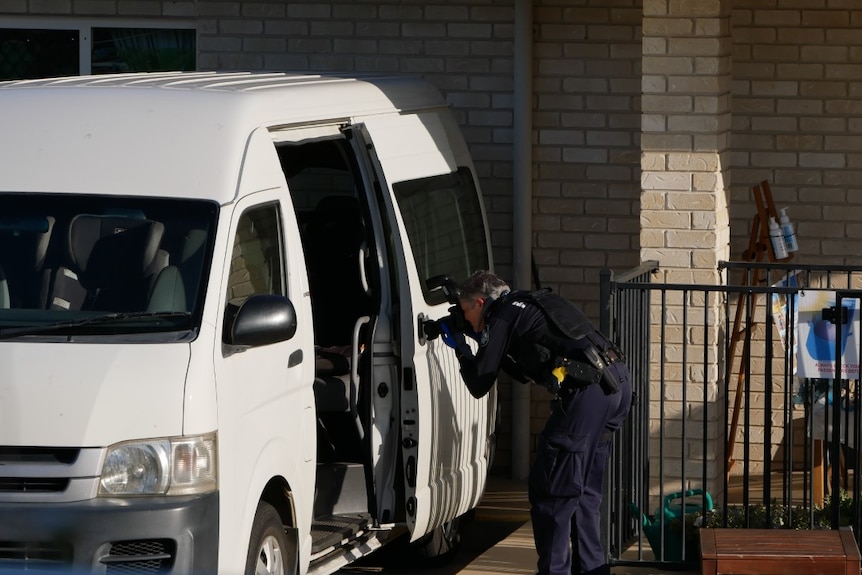 Detective photographs a minibus from a daycare center where a child was abandoned