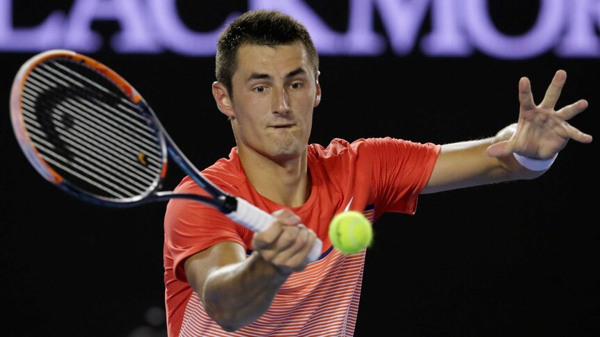 Bernard Tomic plays a forehand in his third round match against John Millman.