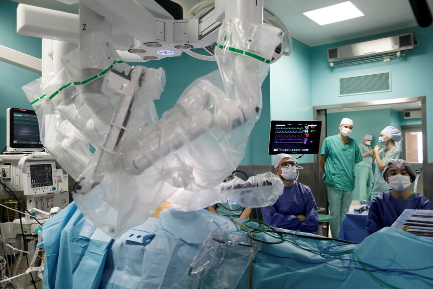 Medical staff use a robotic surgical system