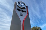 Large sign with the Holden and GM logos advertising the Neil Beer car dealership.